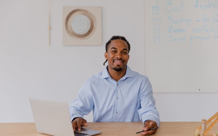 A man working at a laptop in an office